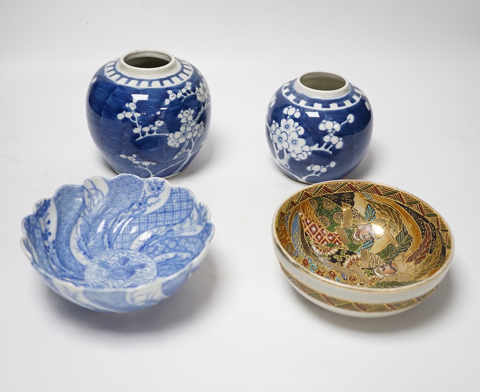 A collection of seven Chinese Prunus blossom jars, three with covers and two bowls